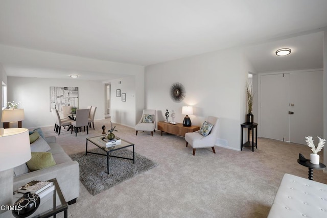 living room featuring carpet floors and baseboards