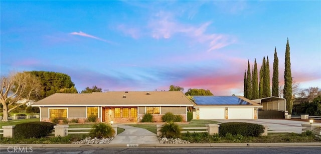 ranch-style home with concrete driveway and a garage