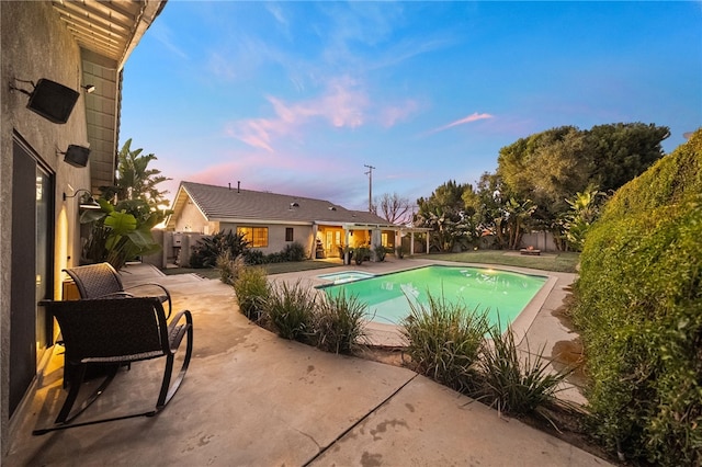 pool at dusk featuring a patio area, a fenced in pool, and fence private yard