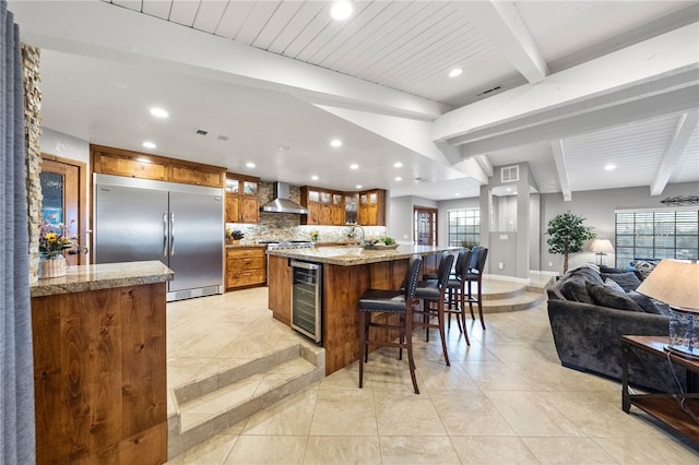 26280 Thacker Dr, Hemet, CA 92544 - kitchen with recessed lighting, brown cabinets, wall chimney exhaust hood, built in fridge, and beverage cooler