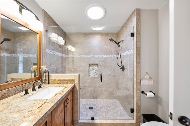 full bath with a shower stall, vanity, and toilet