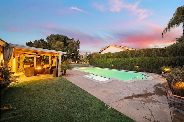 view of swimming pool featuring a lawn, a patio, and a fenced in pool