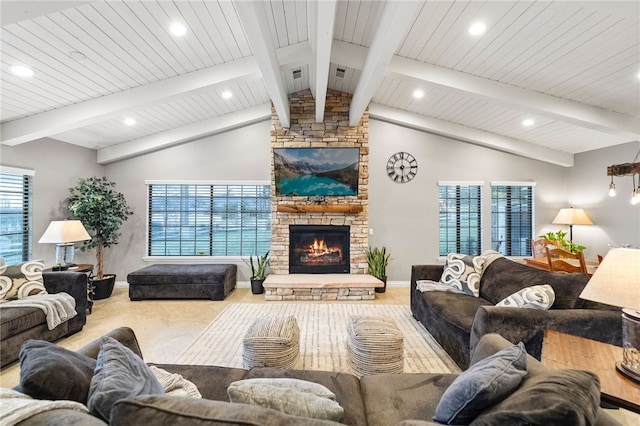 living area featuring visible vents, baseboards, vaulted ceiling with beams, recessed lighting, and a fireplace