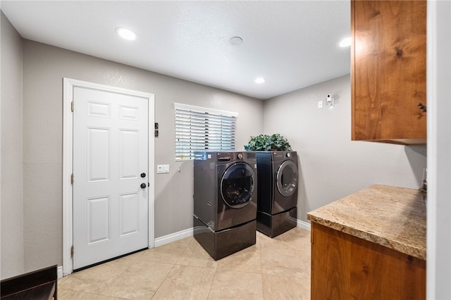 laundry room with baseboards, light tile patterned floors, recessed lighting, cabinet space, and separate washer and dryer