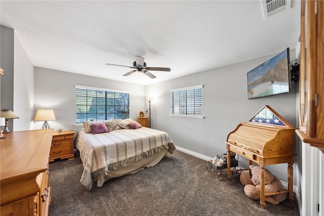 bedroom featuring visible vents, baseboards, carpet floors, a textured ceiling, and a ceiling fan