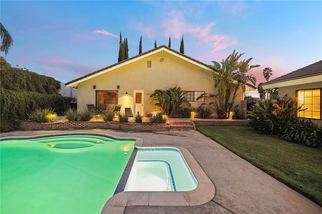 view of swimming pool with a patio area and a pool with connected hot tub