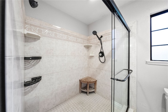 full bathroom featuring a shower stall and toilet