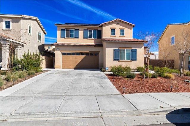 mediterranean / spanish-style house with a tile roof, stucco siding, an attached garage, fence, and driveway