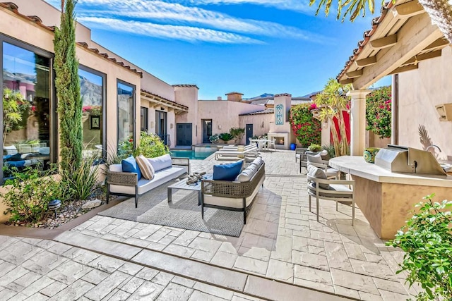 view of patio / terrace with an outdoor hangout area and exterior kitchen