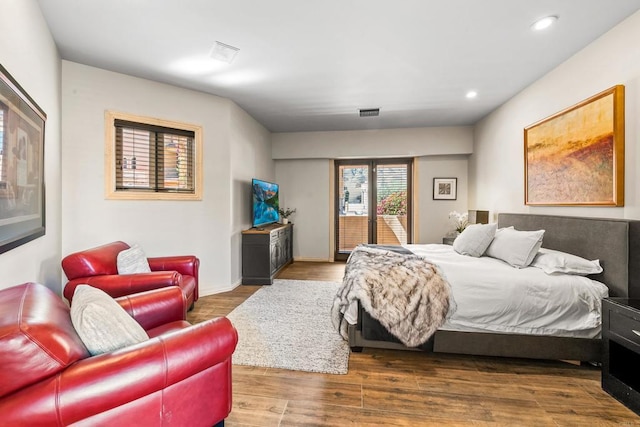 bedroom featuring recessed lighting, visible vents, dark wood-type flooring, access to outside, and baseboards