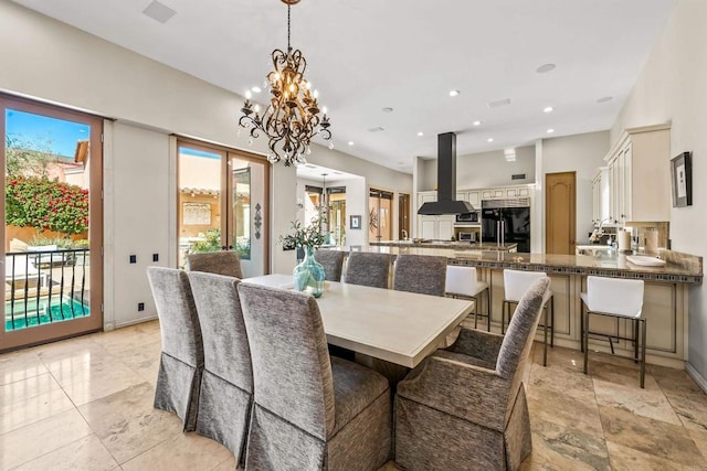 dining space with recessed lighting and an inviting chandelier