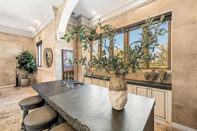 dining room with baseboards and ornamental molding