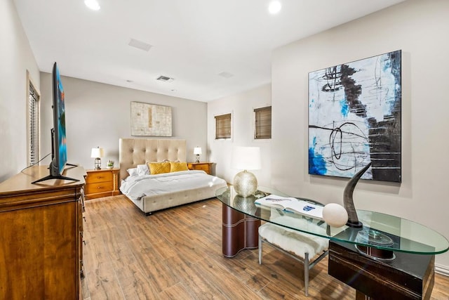 bedroom featuring wood finished floors and recessed lighting