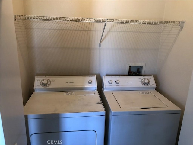 clothes washing area featuring laundry area and washer and clothes dryer