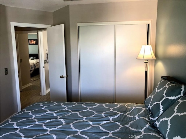 bedroom featuring a closet and wood finished floors