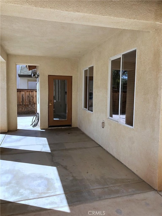 view of patio featuring fence