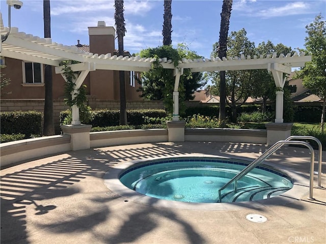 view of pool with a community hot tub, fence, and a pergola