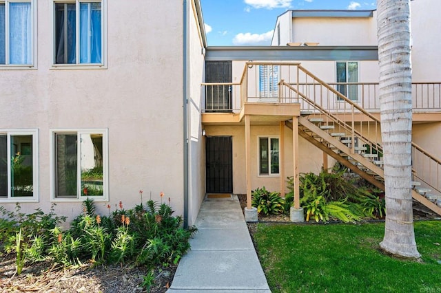 entrance to property featuring stucco siding