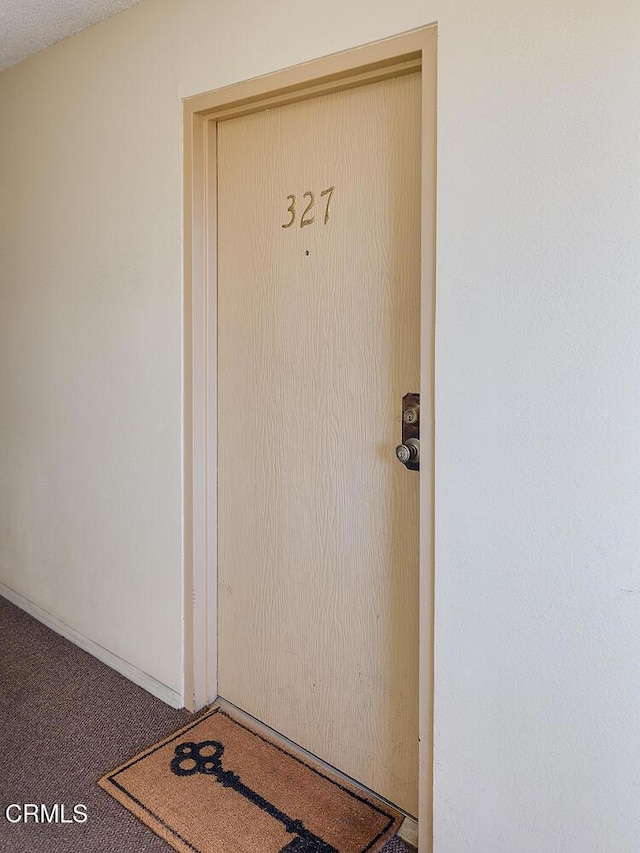 doorway to property with stucco siding