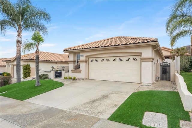 mediterranean / spanish house with stucco siding, a gate, a tile roof, concrete driveway, and an attached garage