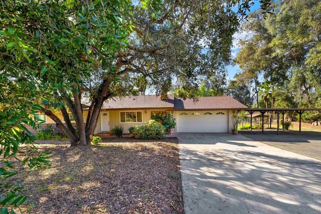 single story home featuring driveway, a carport, and an attached garage