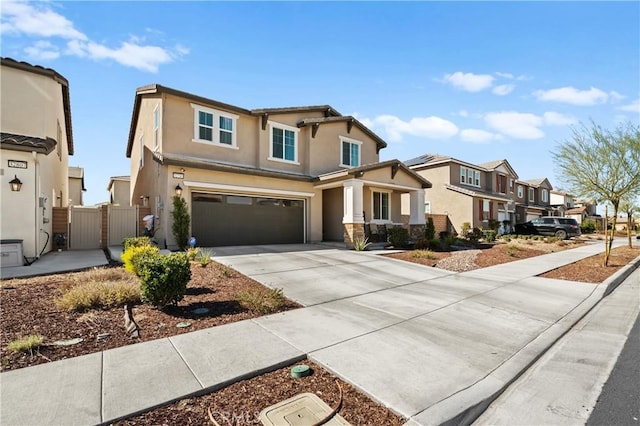 view of front of house with stucco siding, concrete driveway, an attached garage, fence, and a residential view