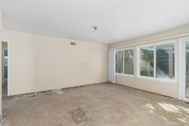 empty room with concrete flooring and visible vents