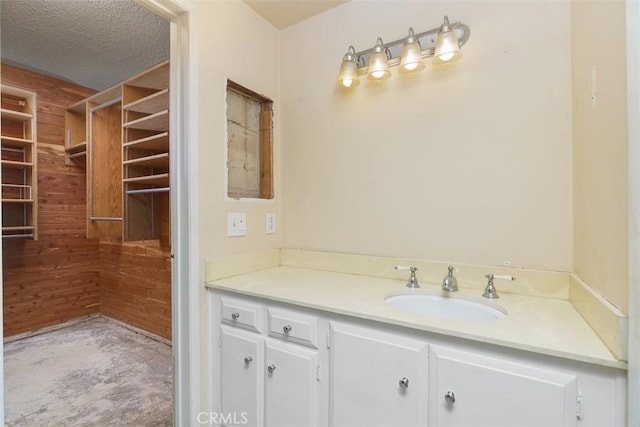 bathroom with a textured ceiling and vanity