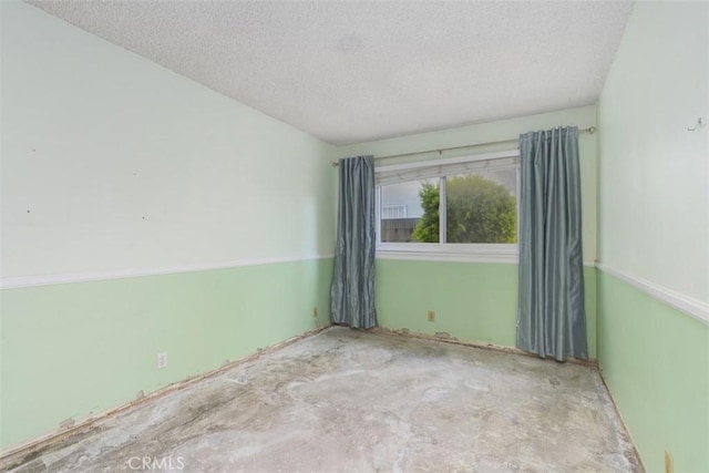 unfurnished room featuring a textured ceiling