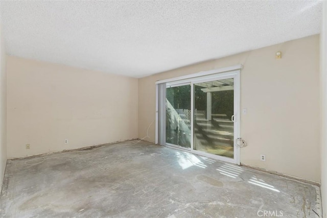 unfurnished room with a textured ceiling