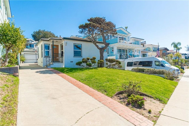 view of front of property with a front lawn, a residential view, and stucco siding