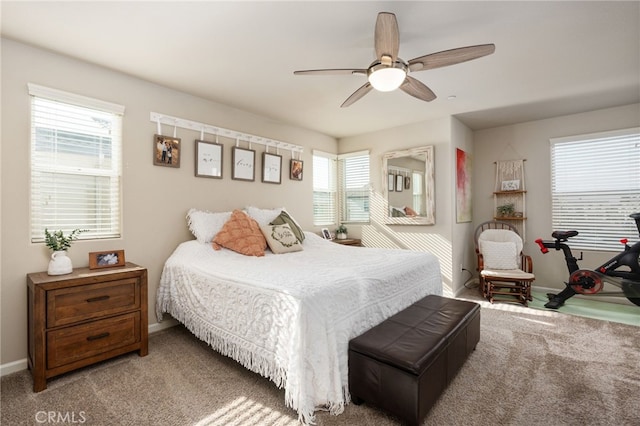 carpeted bedroom with a ceiling fan and baseboards