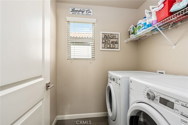 laundry area with washing machine and dryer, laundry area, and baseboards