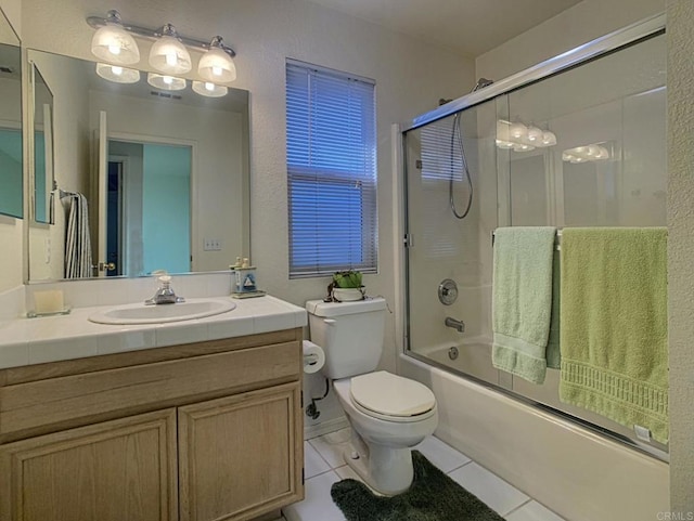 full bath with toilet, shower / bath combination with glass door, tile patterned flooring, and vanity