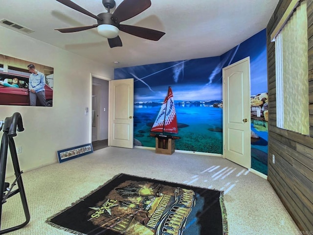 interior space featuring carpet floors, visible vents, and a ceiling fan