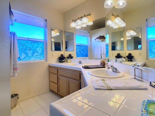 bathroom with baseboards, plenty of natural light, vanity, and tile patterned floors