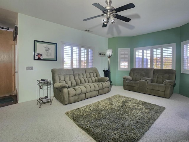 living room featuring visible vents and a ceiling fan