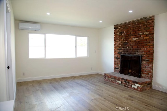 3659 W 110th St, Inglewood, CA 90303 - unfurnished living room featuring a wall unit AC, wood finished floors, baseboards, recessed lighting, and a fireplace