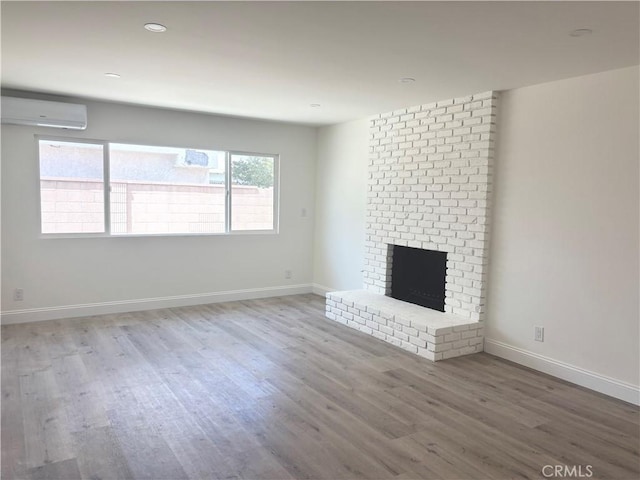 3659 W 110th St, Inglewood, CA 90303 - unfurnished living room featuring a wall mounted AC, wood finished floors, a fireplace, and recessed lighting