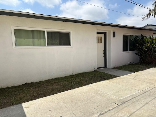 3659 W 110th St, Inglewood, CA 90303 - view of exterior entry featuring stucco siding and a patio