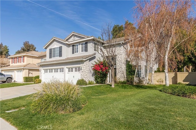 view of front of property featuring driveway, an attached garage, fence, a front lawn, and stucco siding