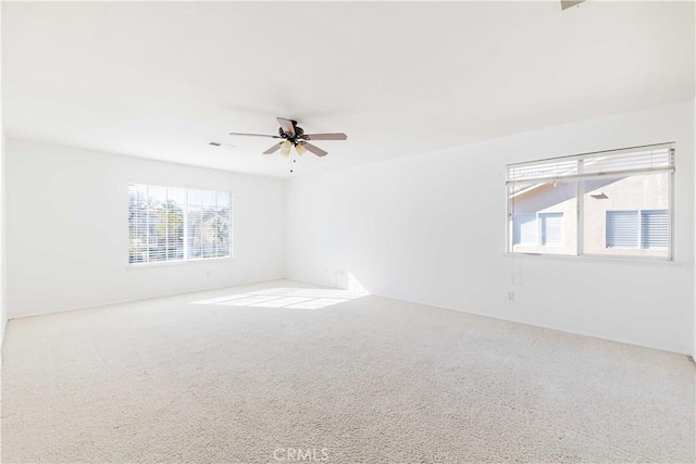 empty room featuring light carpet and ceiling fan