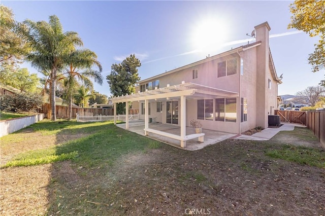 rear view of property with a fenced backyard, a yard, stucco siding, a pergola, and a patio area