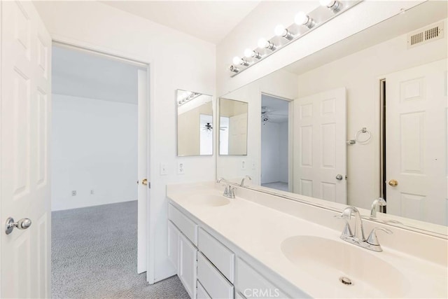 full bath featuring double vanity, visible vents, and a sink