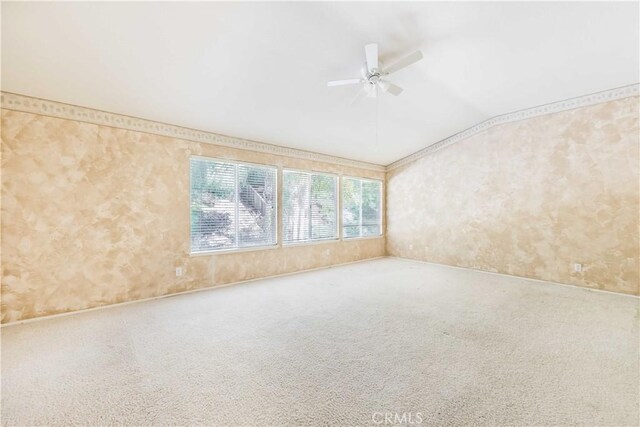 unfurnished room with carpet floors, vaulted ceiling, and a ceiling fan