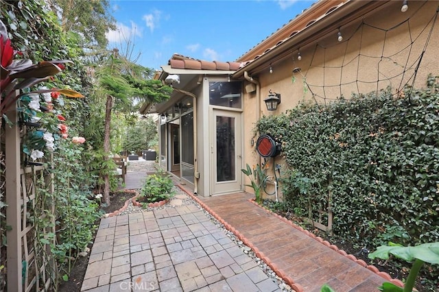 exterior space featuring a patio area and stucco siding