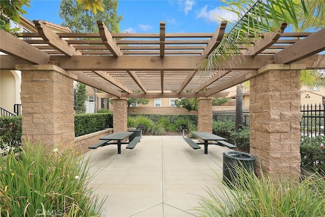 surrounding community featuring a pergola, a patio, and fence