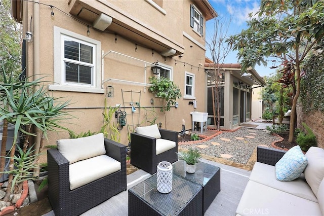 view of patio / terrace featuring a sunroom, fence, an outdoor living space, and a sink