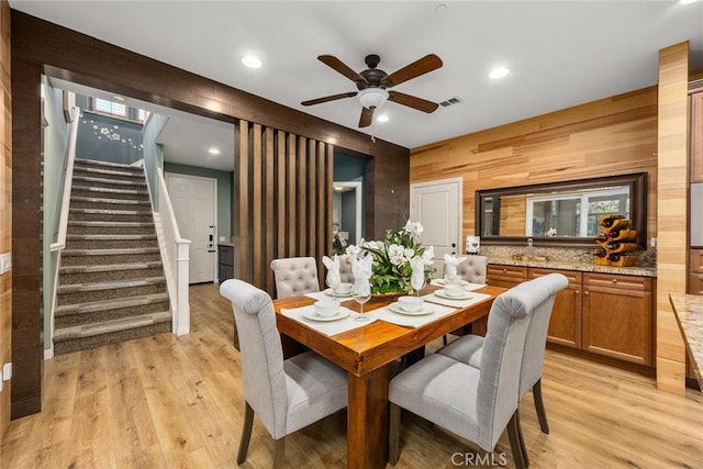 dining area featuring light wood-style floors, recessed lighting, visible vents, and stairway