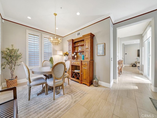 dining room with baseboards and crown molding